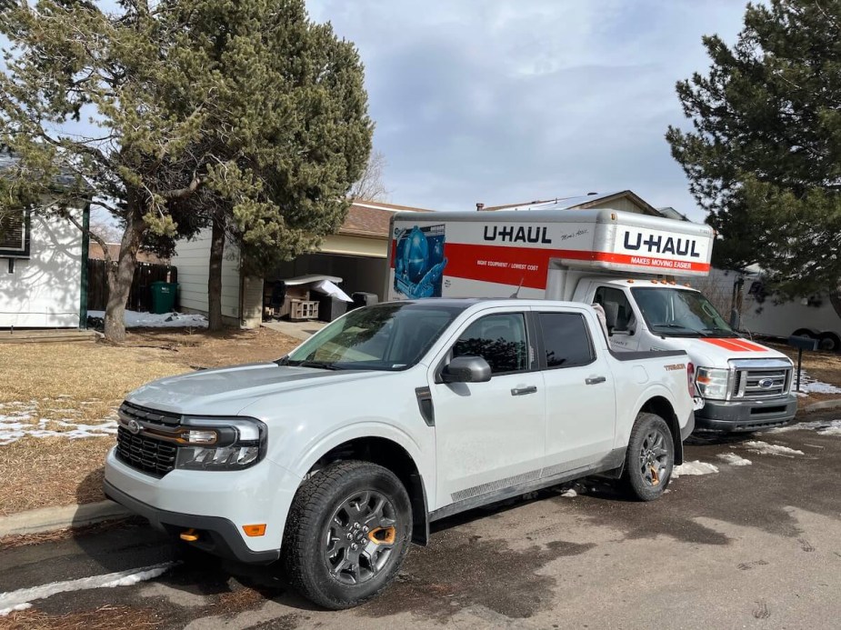 2023 Ford Maverick Tremor in front of a house with a moving truck