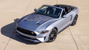 A silver 2023 Ford Mustang Convertible parked on an airstrip in the Sun