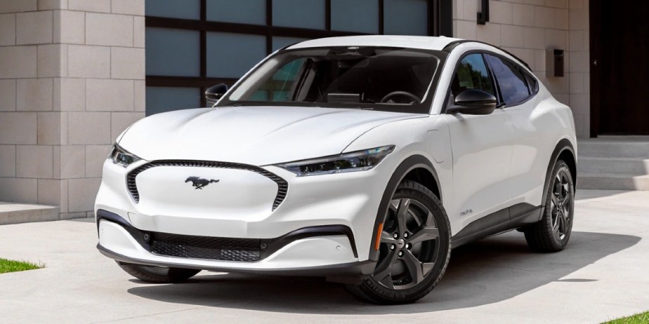 A white 2023 Ford Mustang Mach-E small electric SUV is parked. 