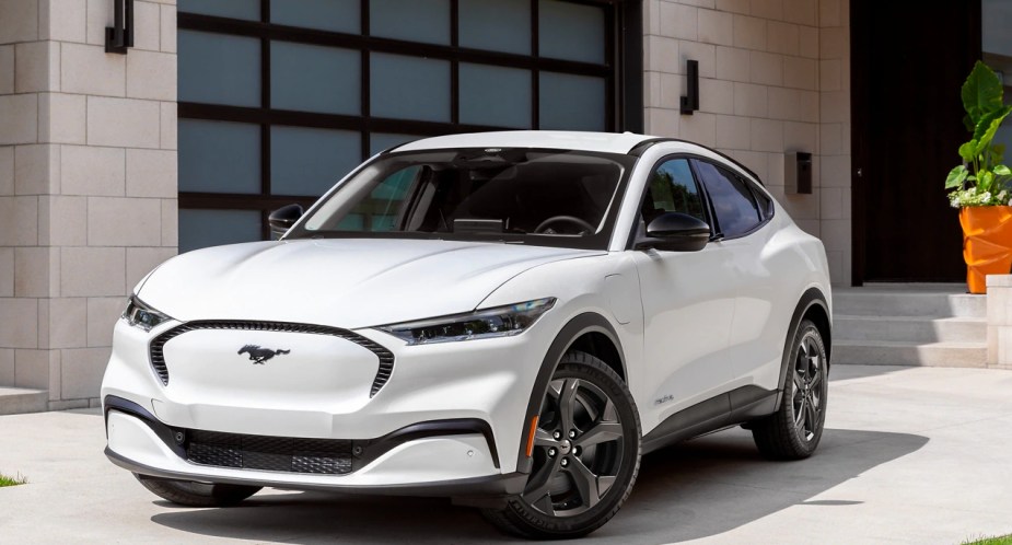 A white 2023 Ford Mustang Mach-E small electric SUV is parked. 