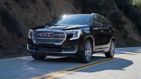 A 2023 GMC Terrain Denali compact crossover SUV model in the Ebony Twilight Metallic paint color option