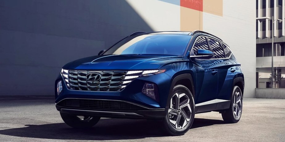 A blue 2023 Hyundai Tucson Hybrid small hybrid SUV is parked. 