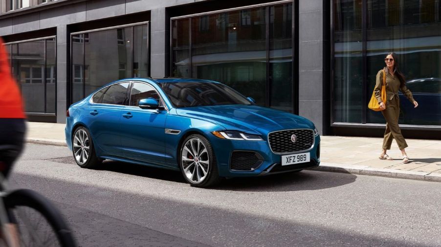 A 20223 Jaguar XF driving down a street.