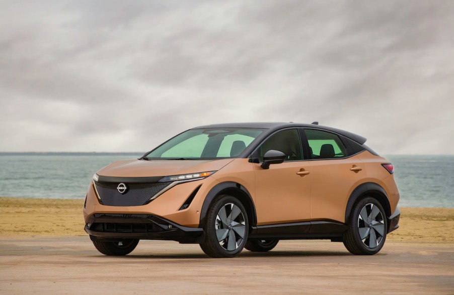 A gold 2023 Nissan Ariya parked outdoors.