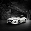 A white Nissan Maxima poses against a dark background.