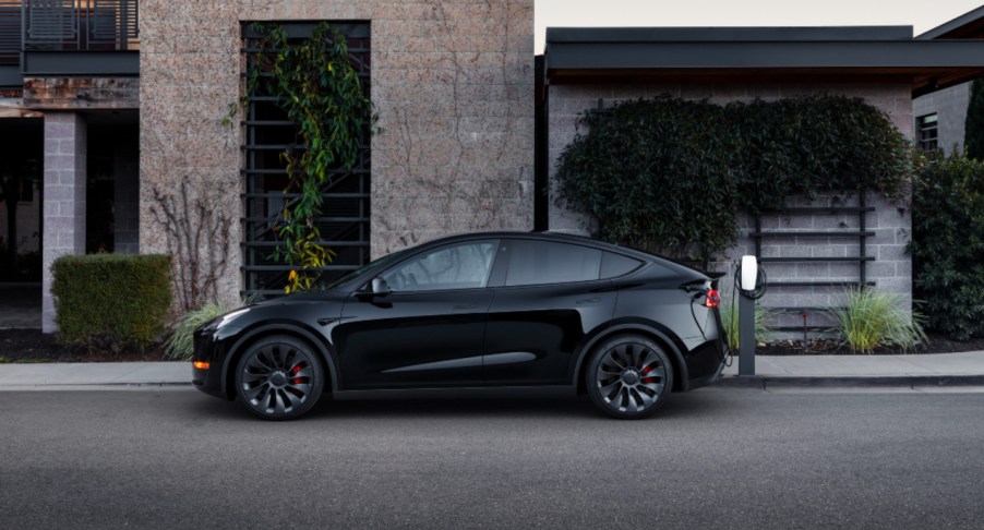 A black Tesla Model Y small electric SUV is parked.