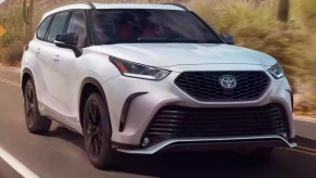 White 2023 Toyota Highlander SUV on the road