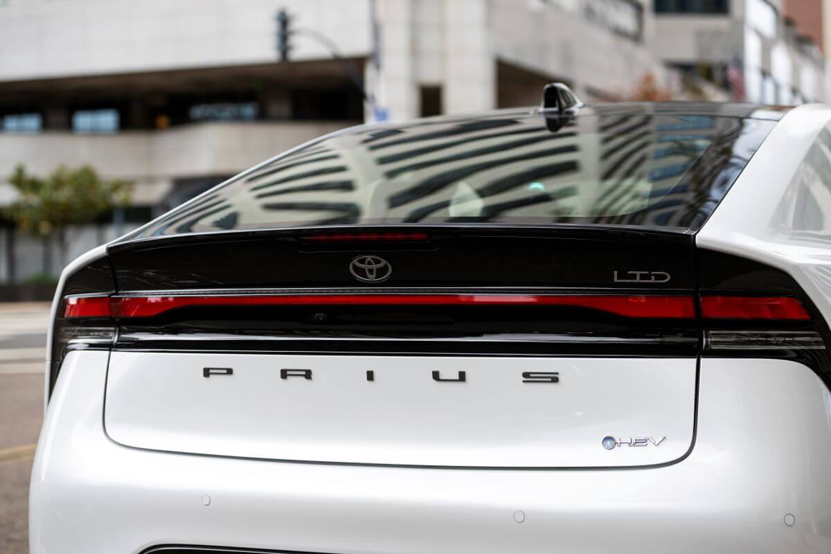 Prius rear badging on the trunk of a white 2023 Toyota Prius hybrid hatchback model