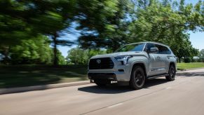 A gray 2023 Toyota Sequoia driving down the road.