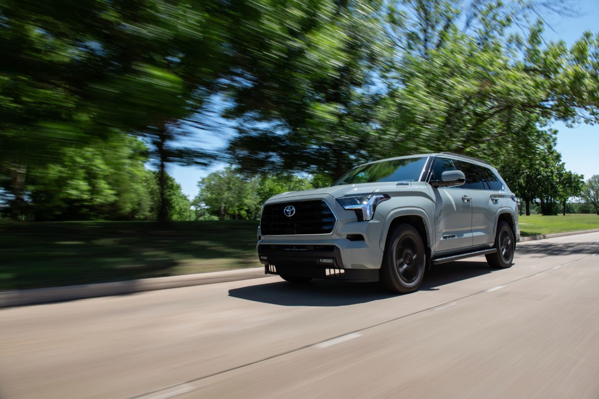 A gray 2023 Toyota Sequoia driving down the road.