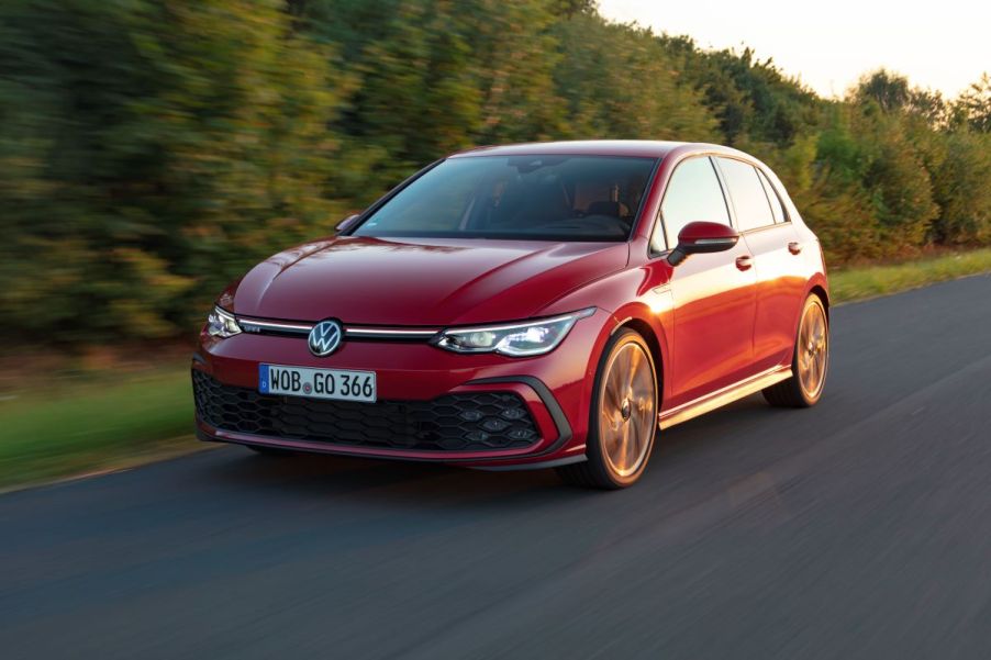 A red Volkswagen GTI drives in the desert