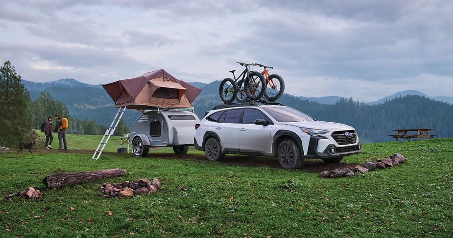 A 2023 Subaru Outback sits in a field. Some owners have complaints about this SUV.