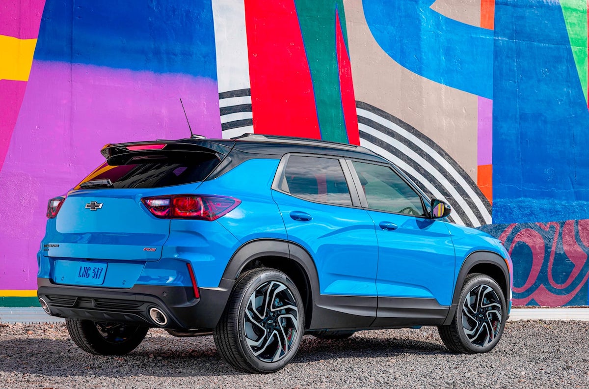 A blue 2024 Chevy Trailblazer parked in front of a colorful mural