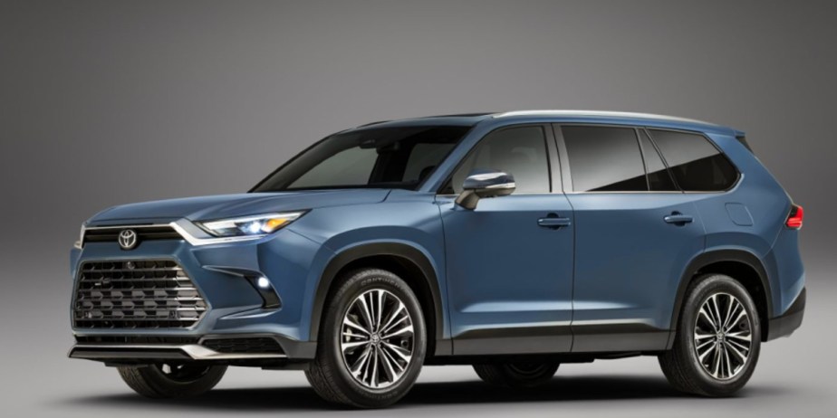 A blue 2024 Toyota Grand Highlander midsize SUV is parked. 