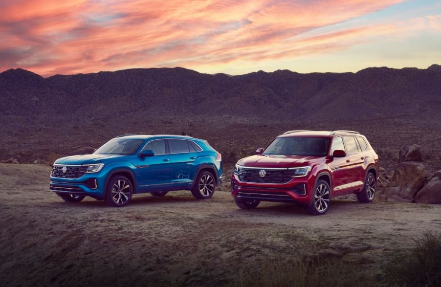 A 2024 Volkswagen Atlas and Atlas Sport on display in an open field.