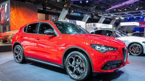 A red Alfa Romeo Stelvio parked indoors.