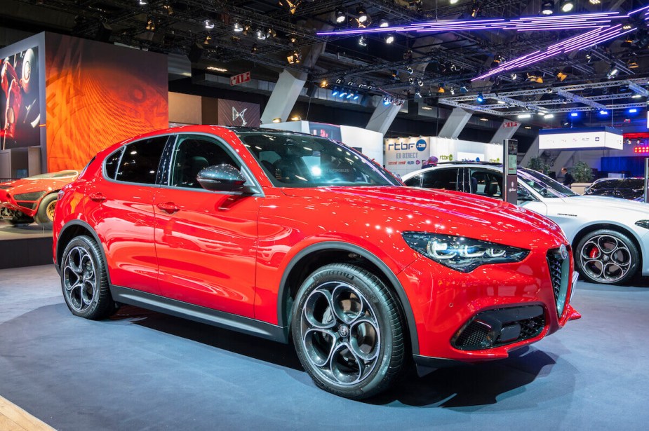 A red Alfa Romeo Stelvio parked indoors. 