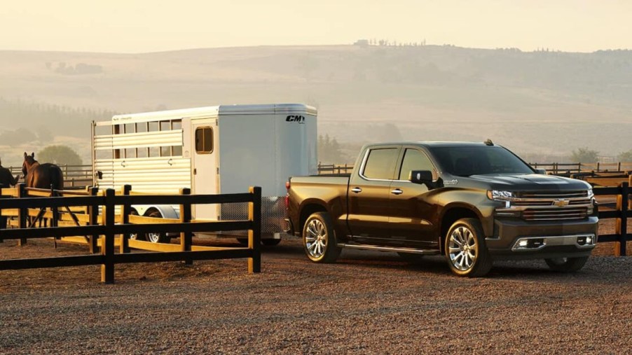 A used Chevy Silverado model hauling a trailer