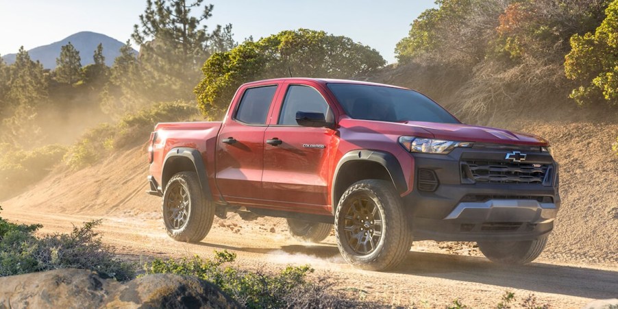 A 2023 Chevrolet Colorado Trail Boss drives off-road. This is an under-rated pickup truck.