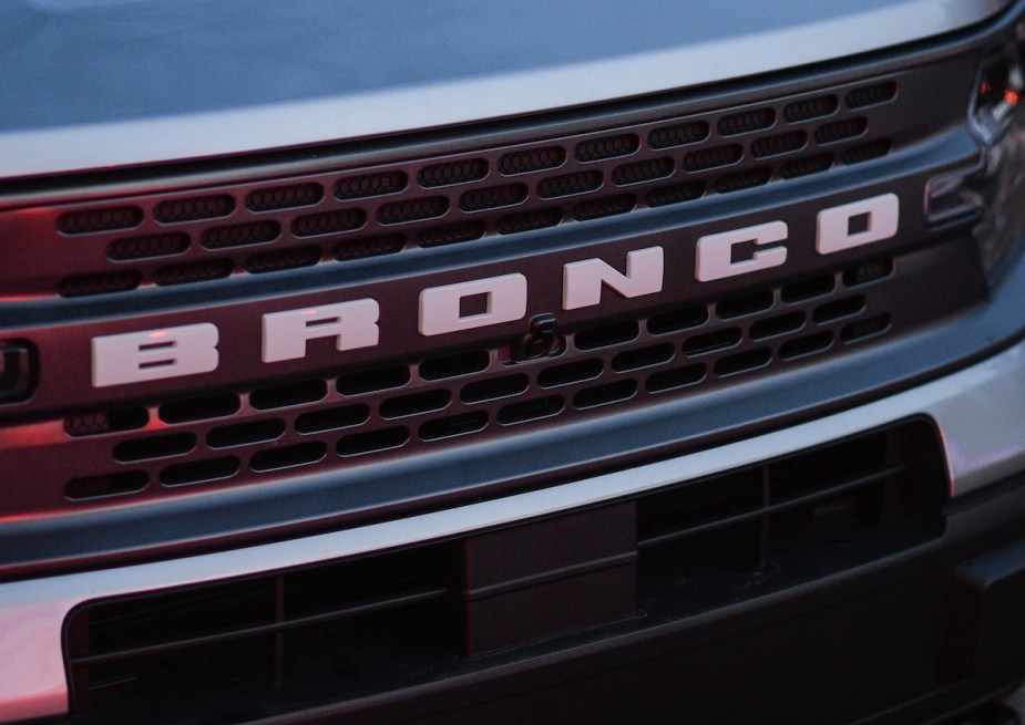 A Ford Bronco logo on the front of a Bronco. 