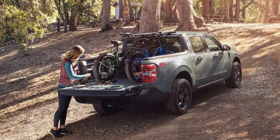 A Ford Maverick pickup truck is parked outdoors with its bed open. 