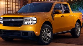 A yellow 2023 Ford Maverick small pickup truck is parked.