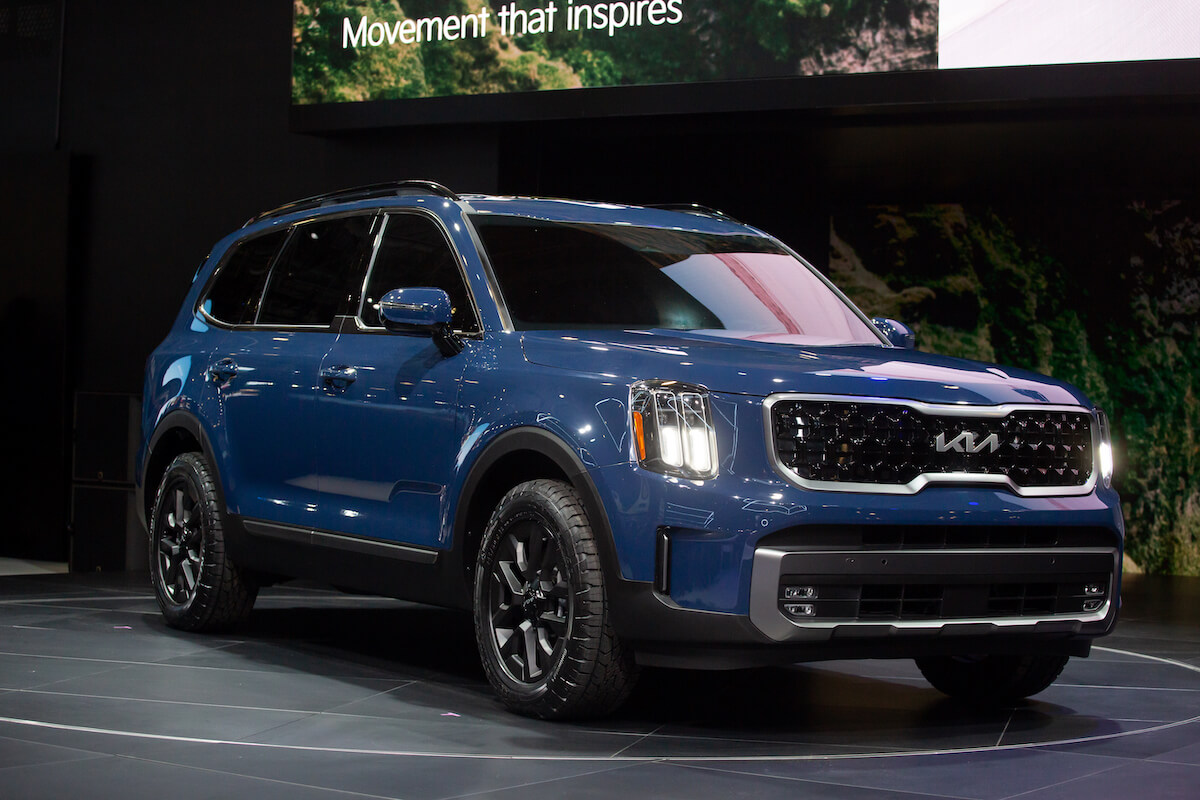 A blue Kia Telluride parked indoor.