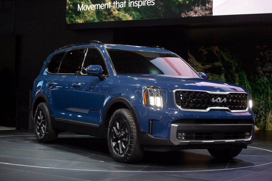 A blue Kia Telluride parked indoor. 