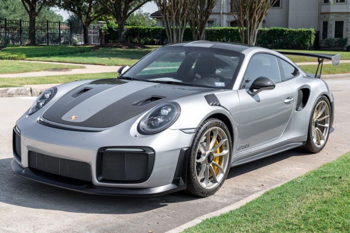 A Silver Porsche 911 GT2 RS with black hood stripes