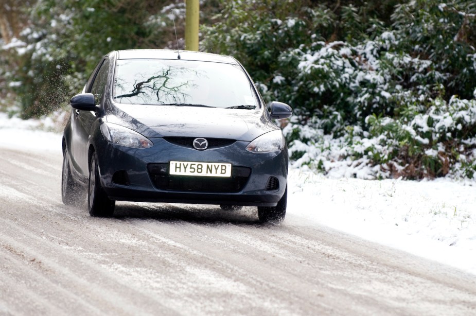 Mazda2 driving on snowy road.