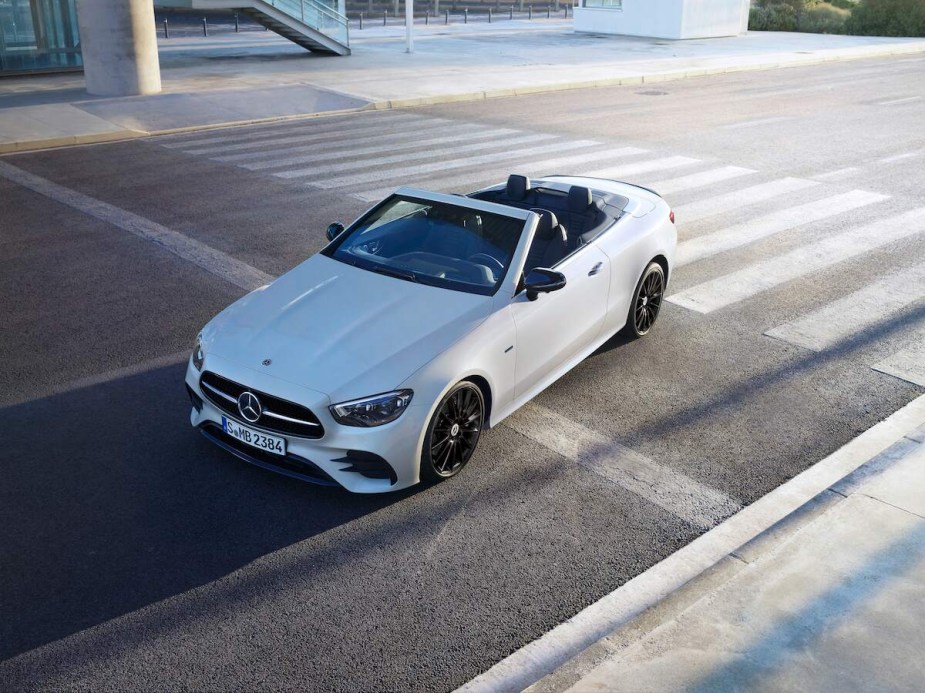 A Mercedes Benz E-Class driving down the road. 