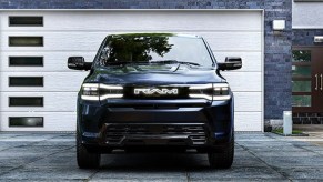 A blue 2025 Ram 1500 REV full-size electric pickup truck is parked.