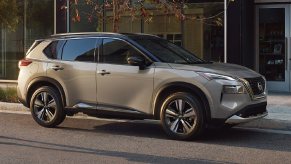 Side view of beige 2023 Nissan Rogue crossover SUV