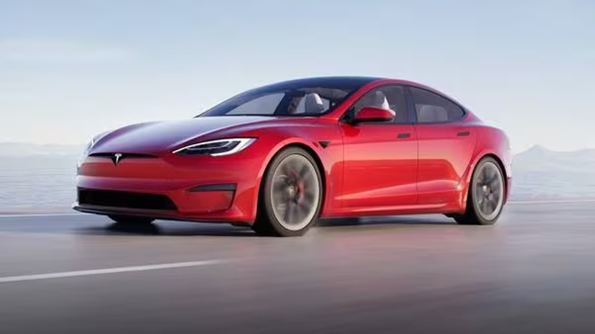 Red Tesla Model S Posed on a Tarmac.