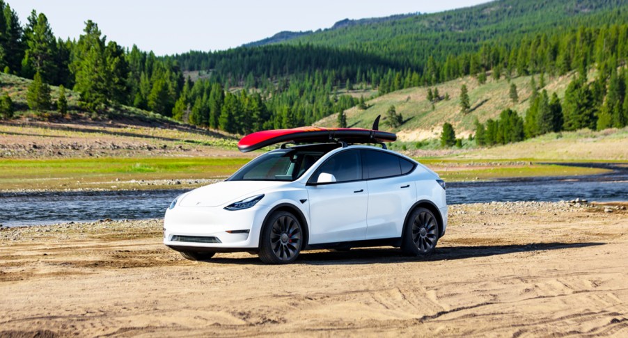 A white 2023 Tesla Model Y small electric SUV is parked.