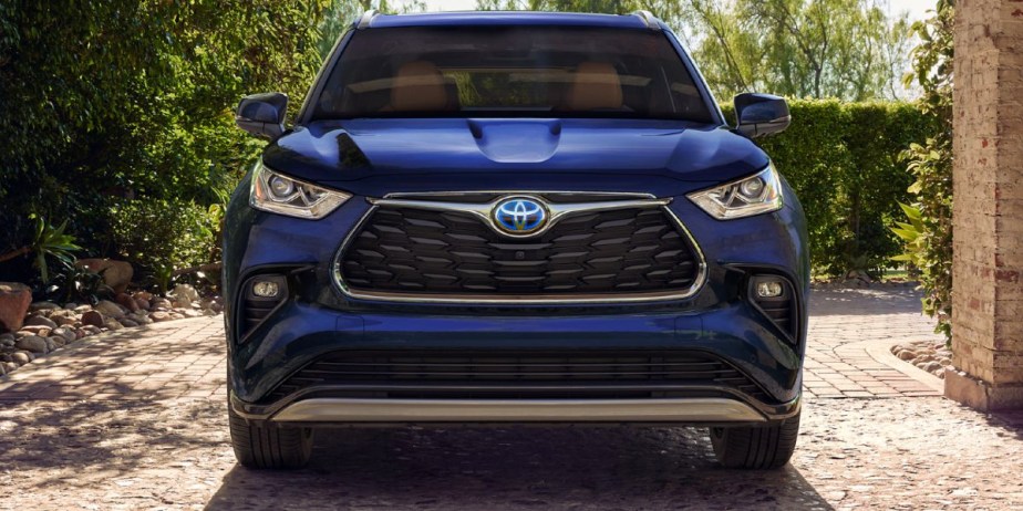 A blue 2023 Toyota Grand Highlander Hybrid midsize hybrid SUV is parked. 