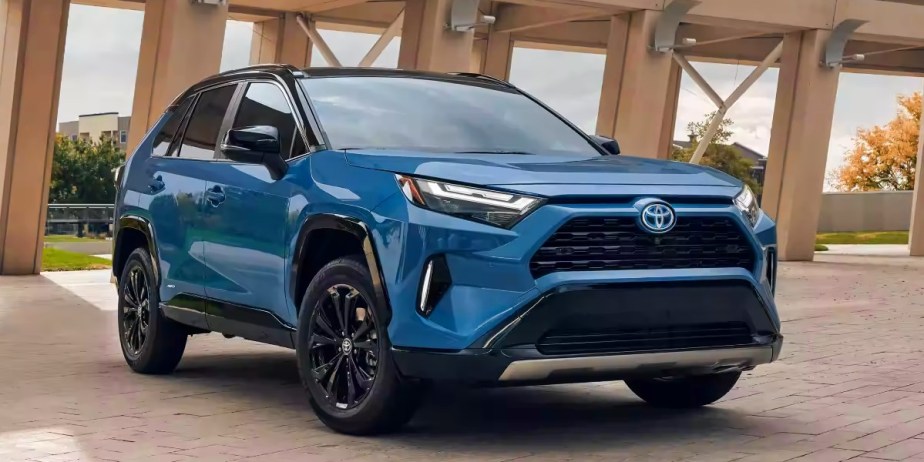 A blue 2023 Toyota RAV4 Hybrid small hybrid SUV is parked. 