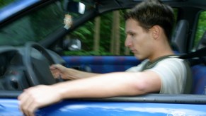 A young man in sleepy in his car.