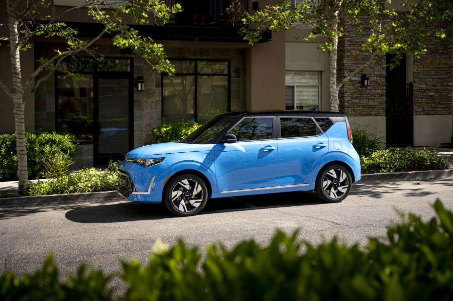 A light blue 2023 Kia Soul subcompact SUV/CUV model parked under tree shade