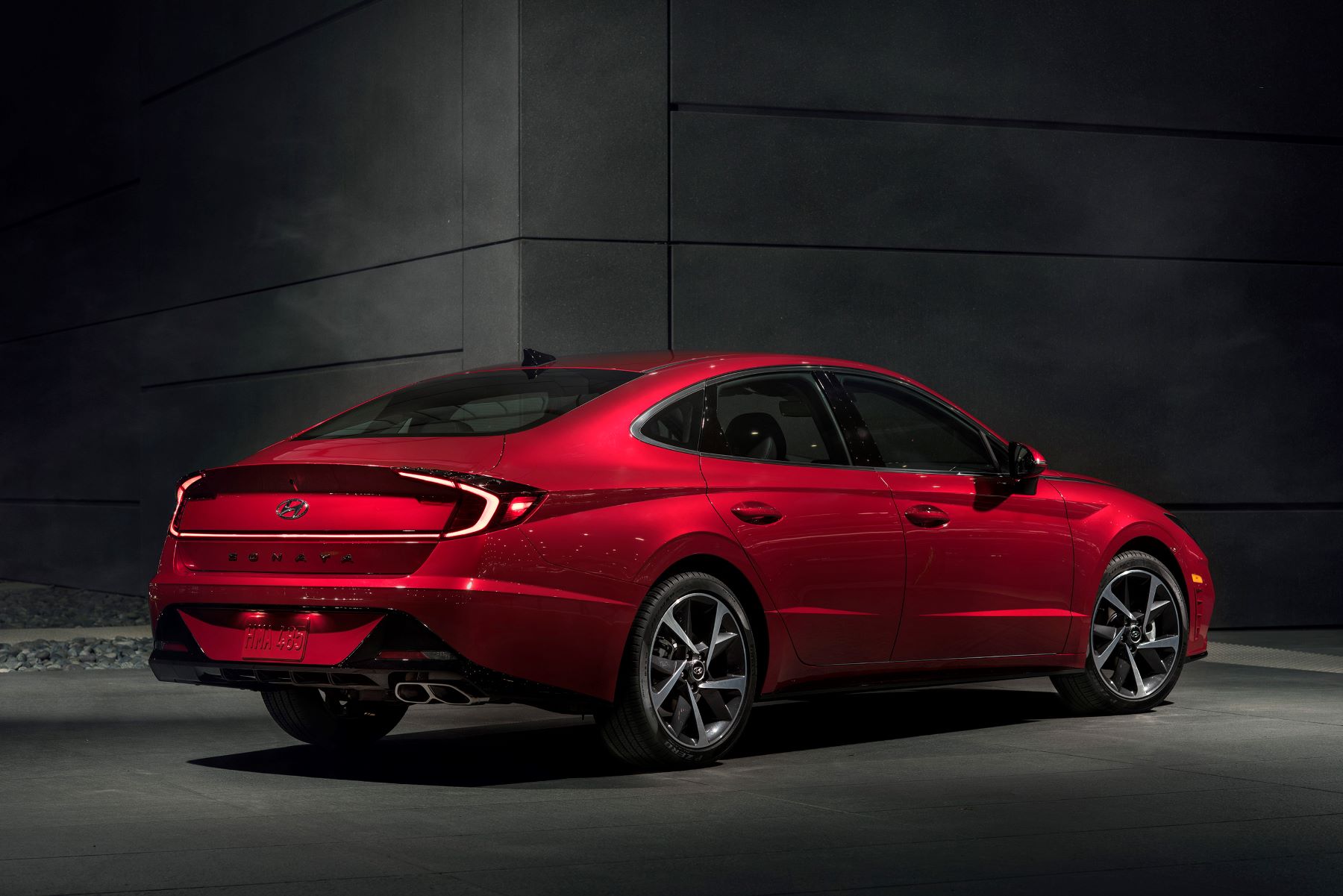 A rear exterior promotional photo of a red 2022 Hyundai Sonata midsize sedan model