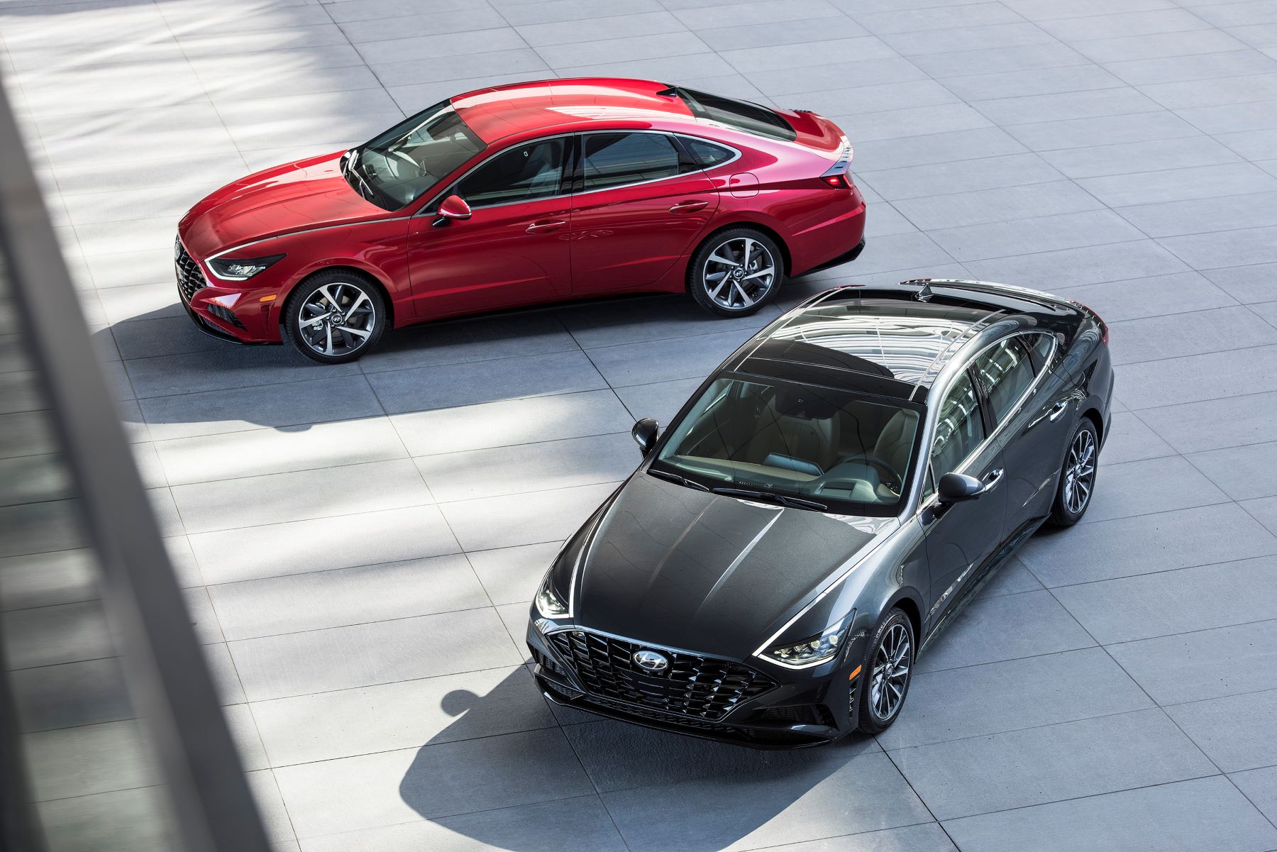 An overhead shot of red and black 2023 Hyundai Sonata midsize sedan models