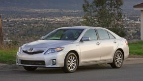 A silver-gray 2010-2011 Toyota Camry Hybrid midsize sedan production model