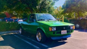 A bright green Volkswagen Rabbit pickup truck in a parking lot.