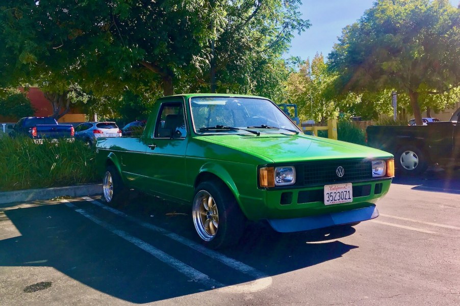 A bright green Volkswagen Rabbit pickup truck in a parking lot.