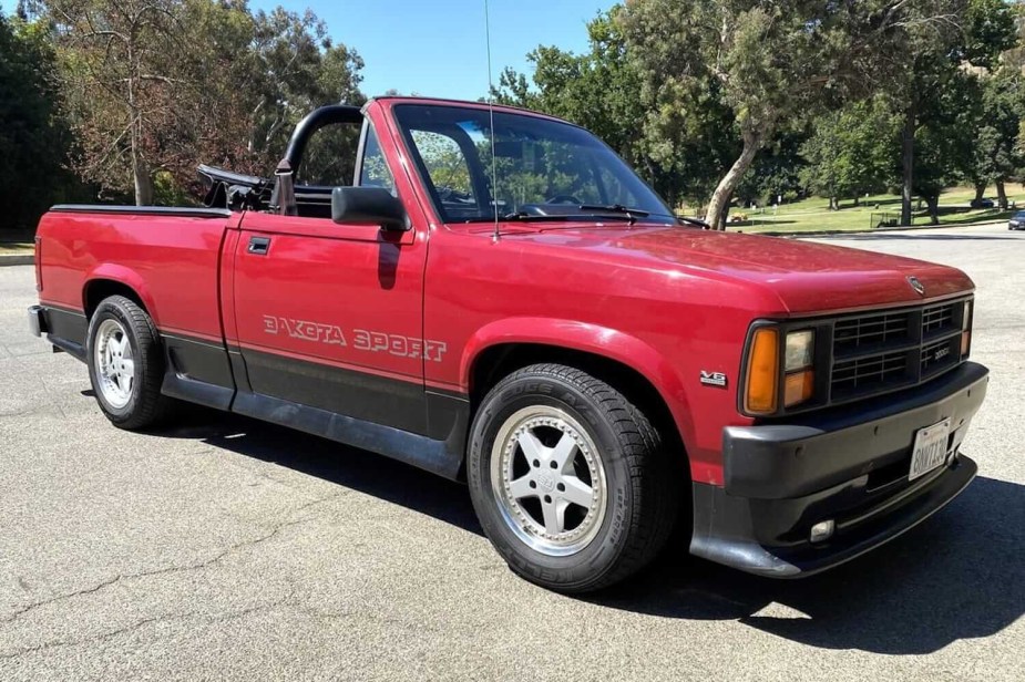 The grille and side of a red Dodge Dakota sport classic convertible pickup truck.