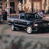 A black 1991 GMC Syclone parked outdoors.