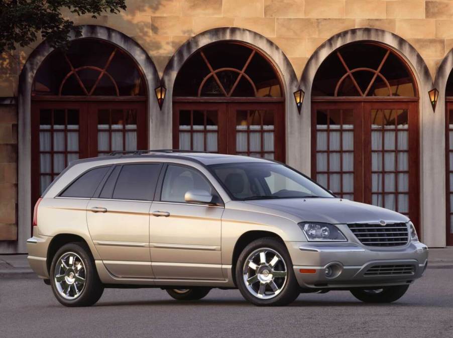 A shiny yellow beige 2005 Chrysler Pacifica Limited minivan model parked in front arched glass doors. The 2005 model is one of the worst Chrysler Pacifica models.