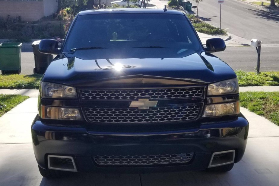 Black Chevrolet 1500 SS pickup truck parked in a driveway.