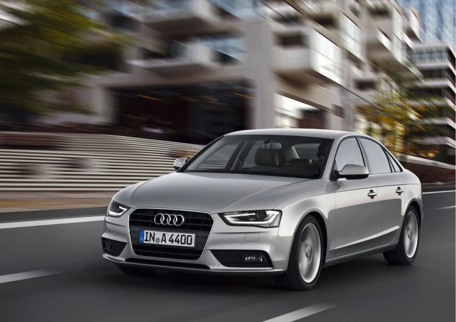 A silver 2011 Audi A4 cruises down city streets.