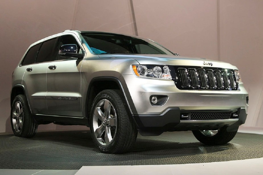 One of the least reliable cars, a 2011 Jeep Grand Cherokee displays its styling on stage.